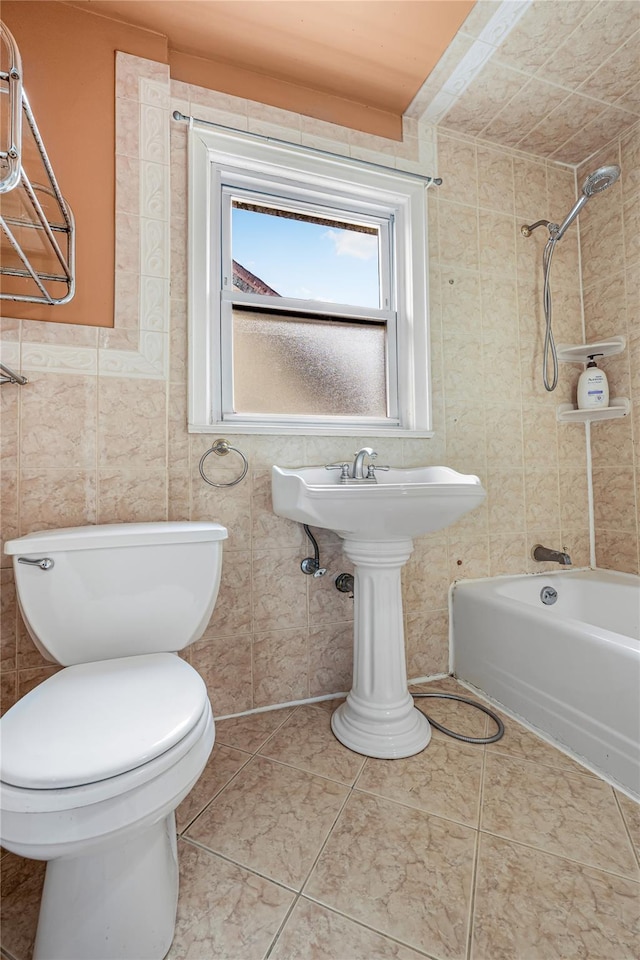 bathroom featuring tile patterned flooring, toilet, and shower / bathtub combination