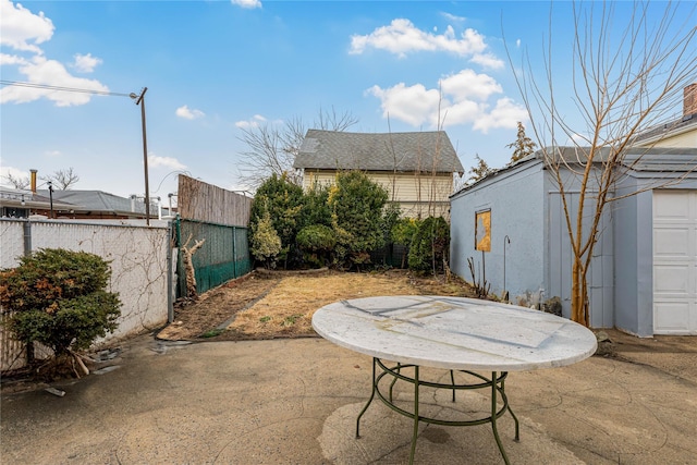 view of patio featuring fence and an outdoor structure