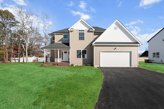 view of front of home featuring a garage, a shingled roof, aphalt driveway, a porch, and a front yard