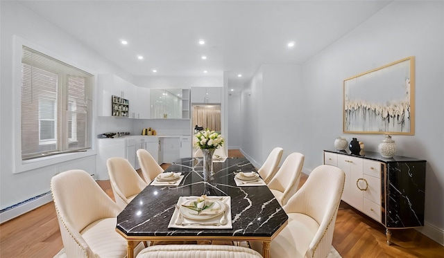 dining area with recessed lighting, baseboards, baseboard heating, light wood-type flooring, and washer / dryer