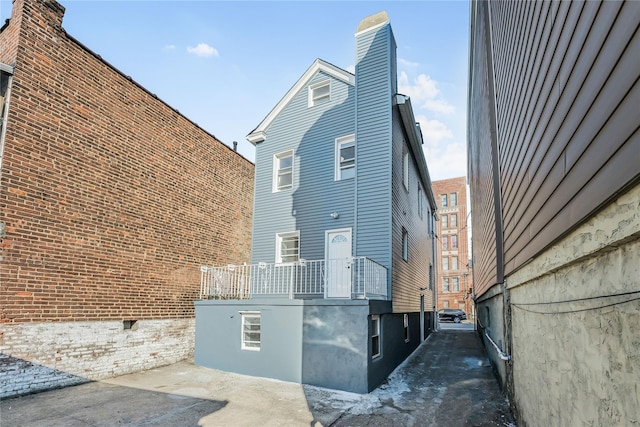 view of side of property with a chimney