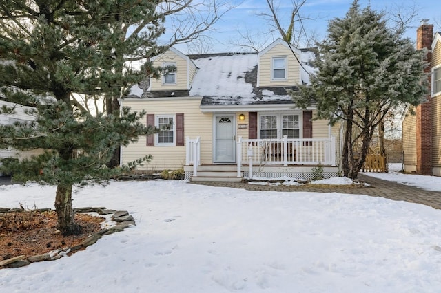 cape cod-style house with covered porch