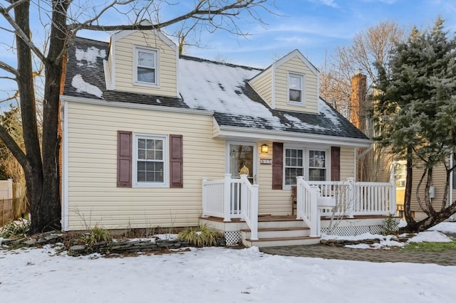 cape cod home with a shingled roof