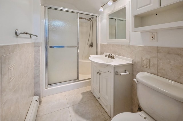 bathroom featuring a stall shower, toilet, and tile walls