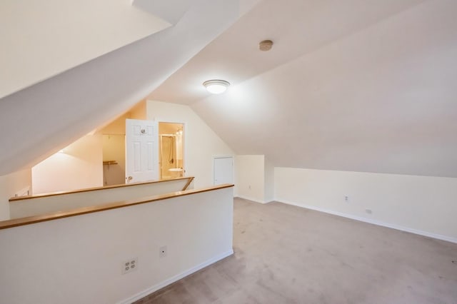 bonus room featuring carpet, baseboards, and vaulted ceiling