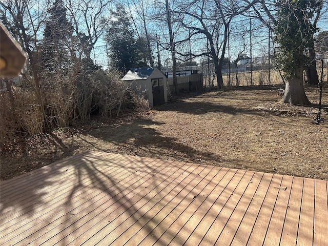 wooden terrace with an outbuilding and a storage shed