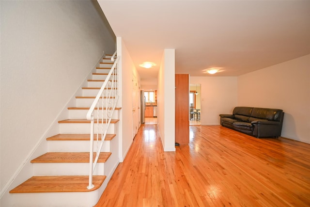 stairs featuring wood finished floors