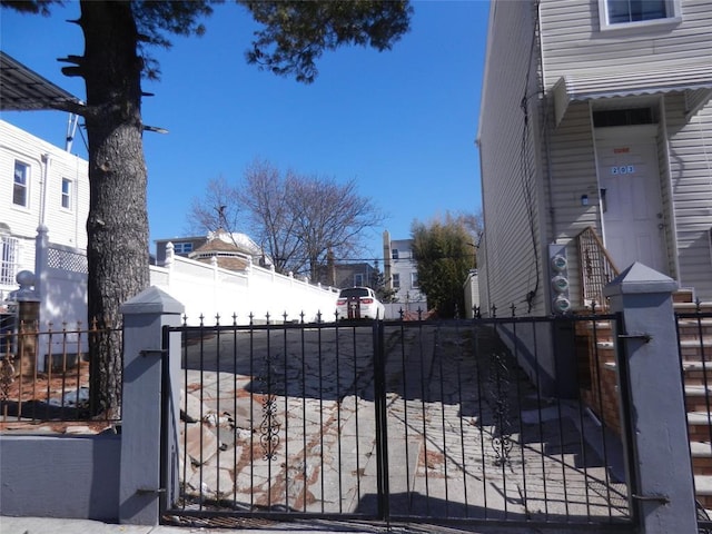 view of gate with a fenced front yard