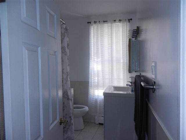 bathroom featuring a baseboard radiator, vanity, toilet, and tile patterned floors