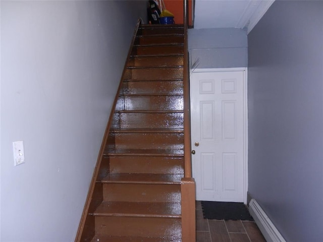 stairs featuring baseboards and baseboard heating