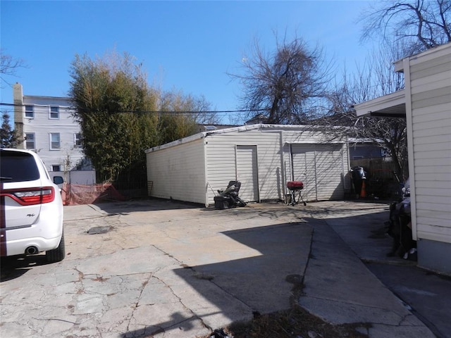 exterior space featuring an outdoor structure and fence