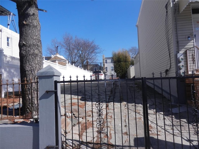 view of gate with a fenced front yard