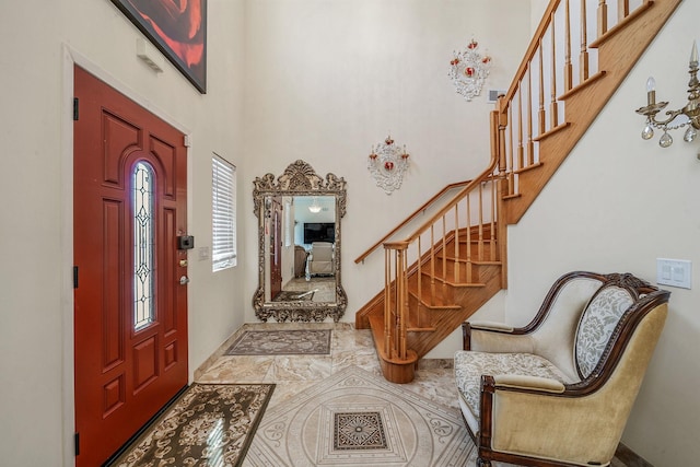 foyer featuring a high ceiling and stairway