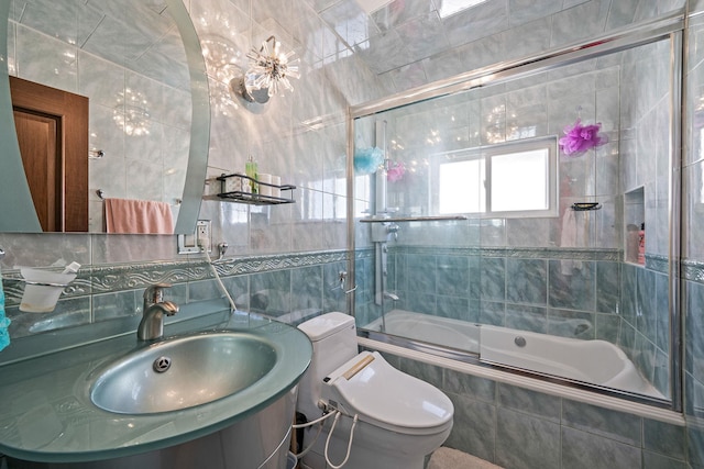 bathroom with toilet, tiled shower / bath combo, a sink, tile walls, and backsplash