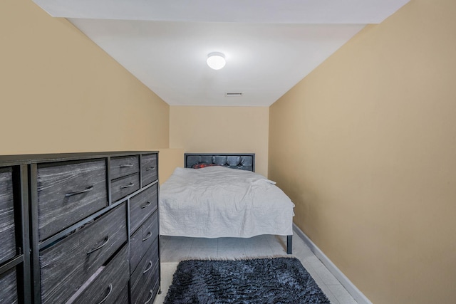 tiled bedroom featuring visible vents and baseboards