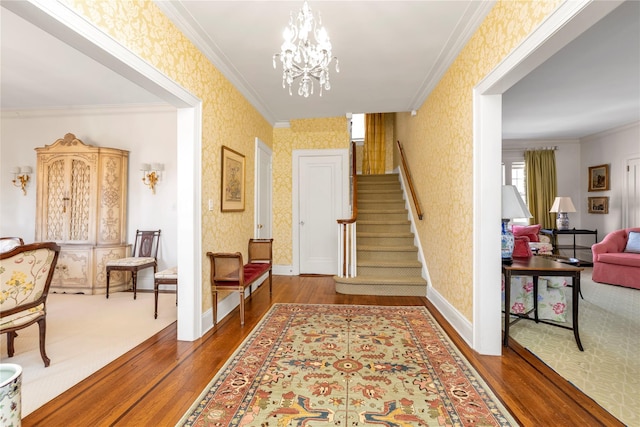 interior space with ornamental molding and wallpapered walls