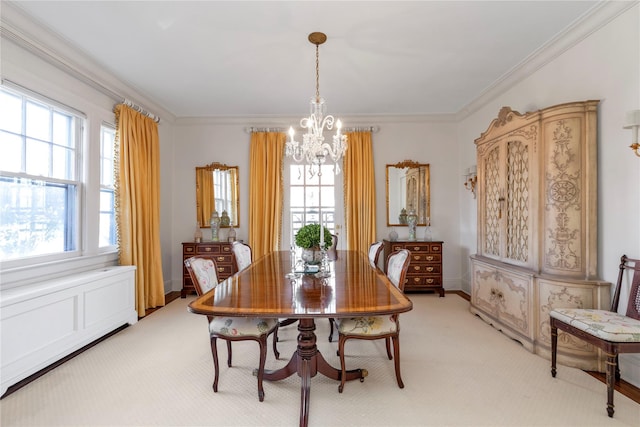 dining room with ornamental molding, a notable chandelier, and light colored carpet