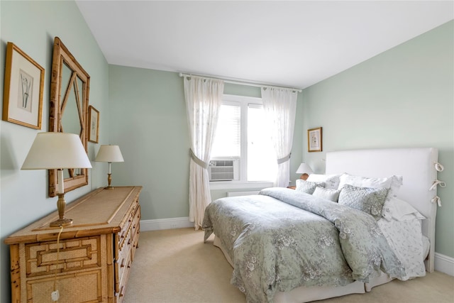 bedroom featuring baseboards, cooling unit, and light colored carpet