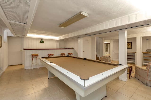 playroom with pool table, a textured ceiling, and light tile patterned flooring