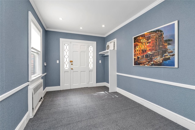 foyer with dark colored carpet, ornamental molding, radiator heating unit, and baseboards