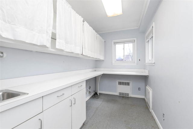 unfurnished office with crown molding, light floors, visible vents, and baseboards