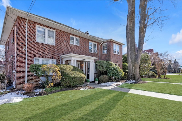 view of front of property with a front yard and brick siding