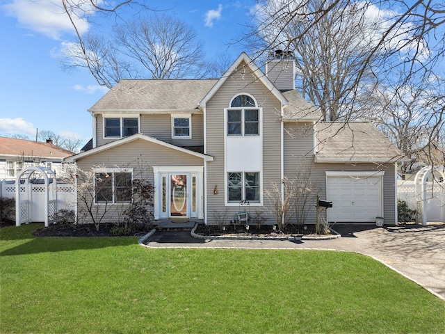 traditional-style home featuring aphalt driveway, a garage, fence, a front lawn, and a chimney