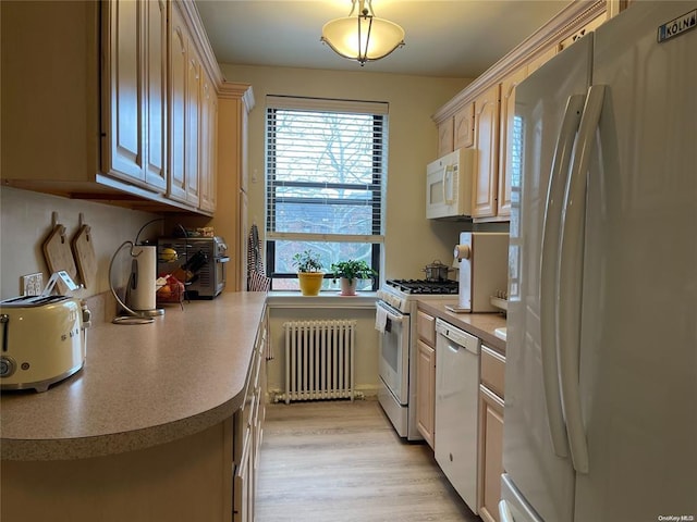 kitchen featuring light countertops, white appliances, light wood-style floors, and radiator