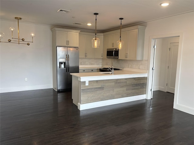 kitchen featuring visible vents, dark wood-type flooring, stainless steel appliances, light countertops, and a sink