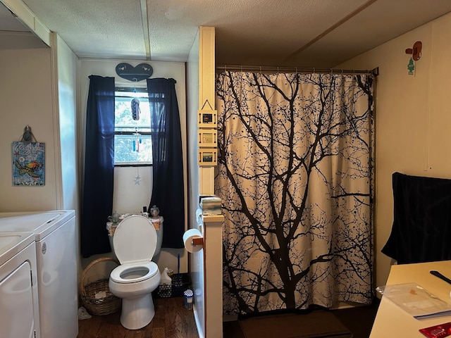 bathroom featuring a textured ceiling, curtained shower, washing machine and dryer, toilet, and wood finished floors