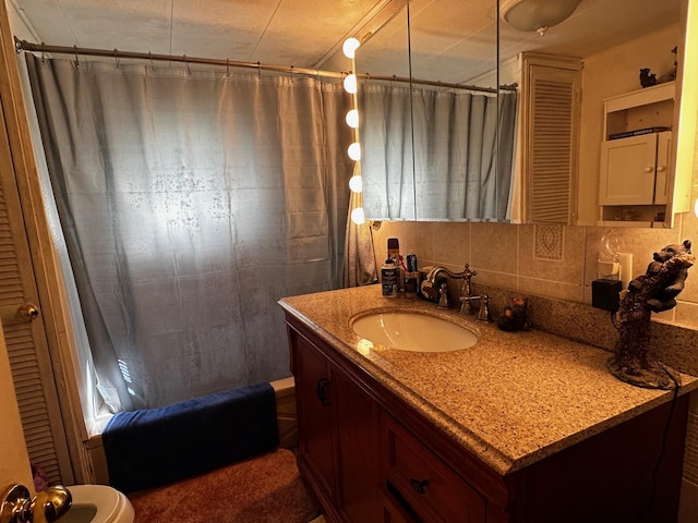 bathroom featuring vanity and decorative backsplash