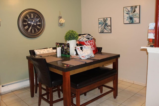 dining room with light tile patterned flooring, baseboards, and a baseboard radiator