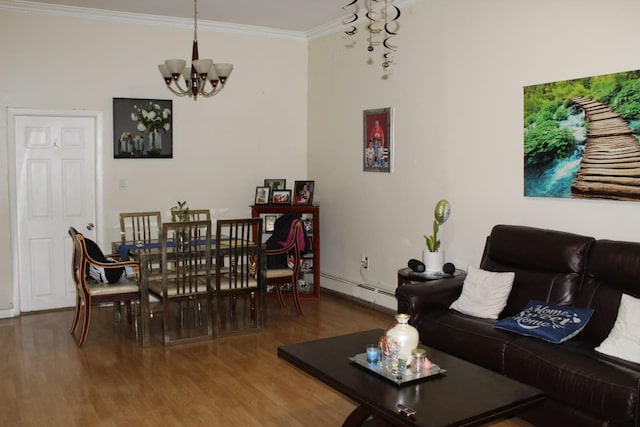 living area with a baseboard heating unit, wood finished floors, a chandelier, and ornamental molding