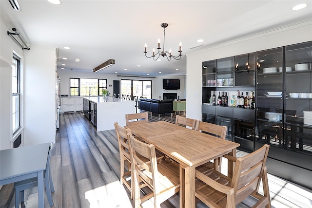 dining area with recessed lighting, visible vents, an inviting chandelier, and wood finished floors