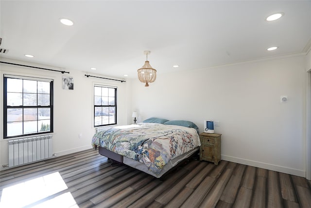 bedroom with recessed lighting, baseboards, wood finished floors, and radiator heating unit