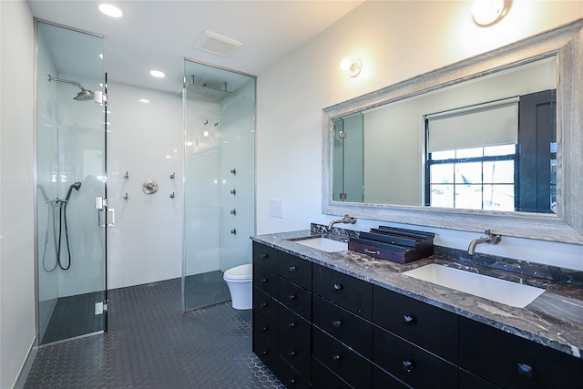 full bathroom with a sink, toilet, a shower stall, and tile patterned flooring