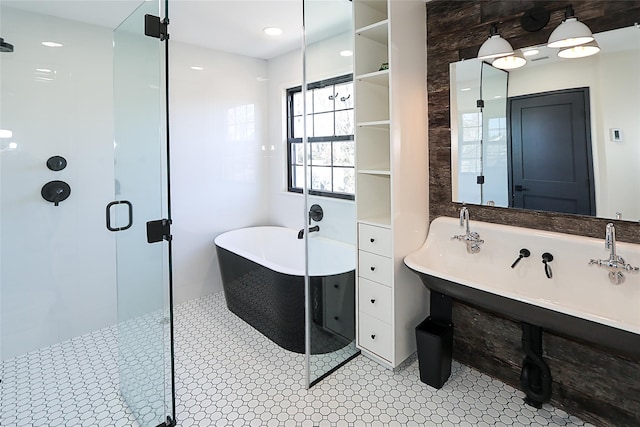 full bathroom with a shower stall and a freestanding tub