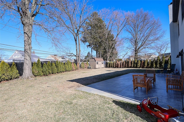 view of yard featuring a fenced backyard, a patio, a storage unit, and an outdoor structure