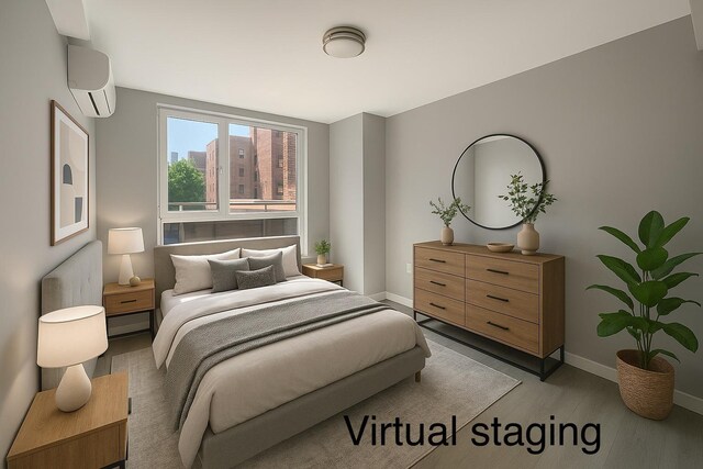 35-20 146th St Unit 3B, Flushing, NY 11354 - bedroom featuring an AC wall unit and light wood-style floors