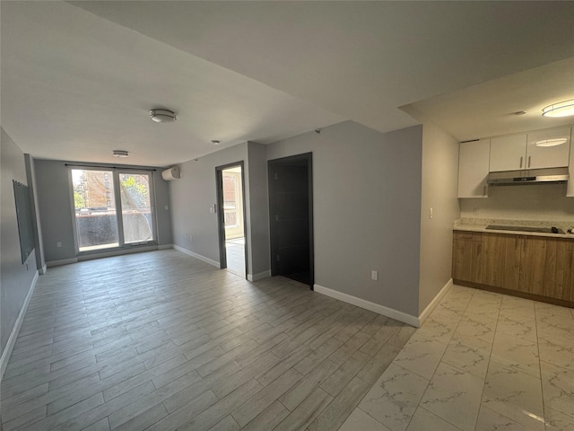 35-20 146th St Unit 3B, Flushing, NY 11354 - unfurnished living room featuring baseboards and light marble finish flooring