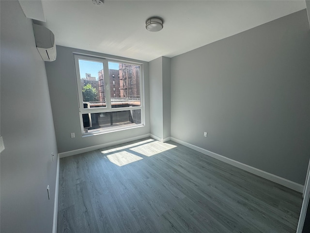 35-20 146th St Unit 3B, Flushing, NY 11354 - spare room with wood finished floors, a wall mounted air conditioner, and a view of city