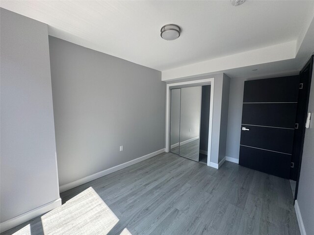 35-20 146th St Unit 3B, Flushing, NY 11354 - unfurnished bedroom featuring wood finished floors and a closet