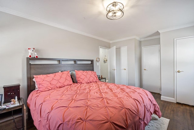 bedroom featuring crown molding and wood finished floors