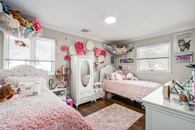 bedroom featuring dark wood-style floors, multiple windows, crown molding, and visible vents