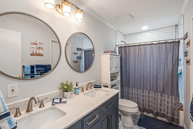 bathroom featuring crown molding, a sink, toilet, and double vanity