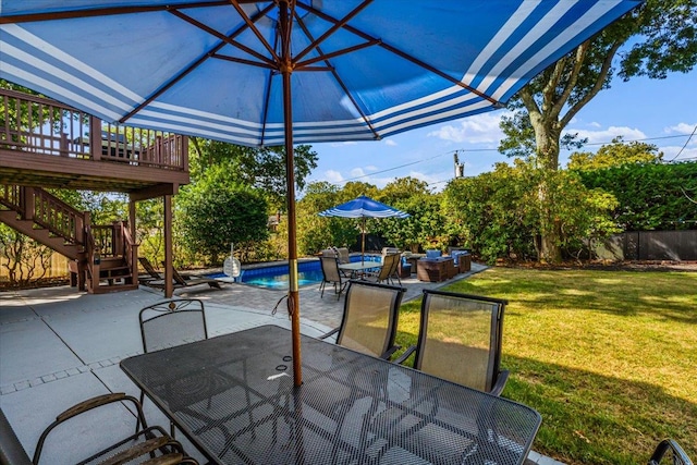 view of patio / terrace with an outdoor pool, stairway, fence, a wooden deck, and outdoor dining space