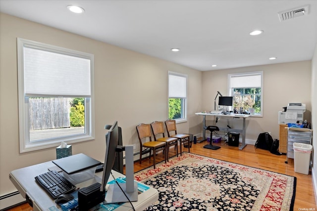 office space with recessed lighting, visible vents, baseboard heating, and wood finished floors