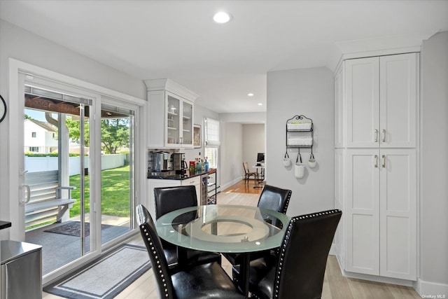 dining room with recessed lighting, baseboards, and light wood finished floors