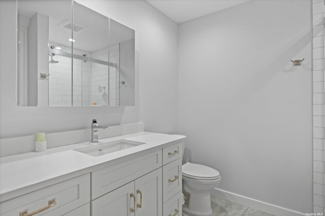 bathroom featuring visible vents, baseboards, toilet, vanity, and a shower stall