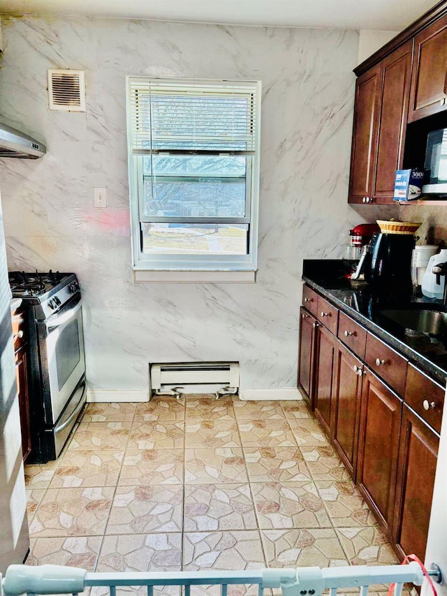 kitchen with stainless steel gas range oven, a baseboard radiator, a sink, visible vents, and dark countertops